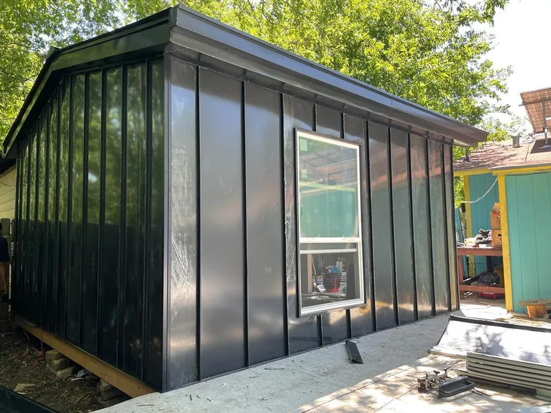 Black standing seam metal wall panels for Roof Inspection in Corrales